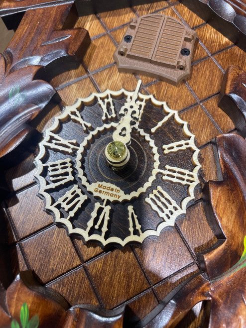Close up view of wooden dial and numerals with "Made in Germany" carved in the middle of dial Close up view of wooden dial and numerals with "Made in Germany" carved in the middle of dial