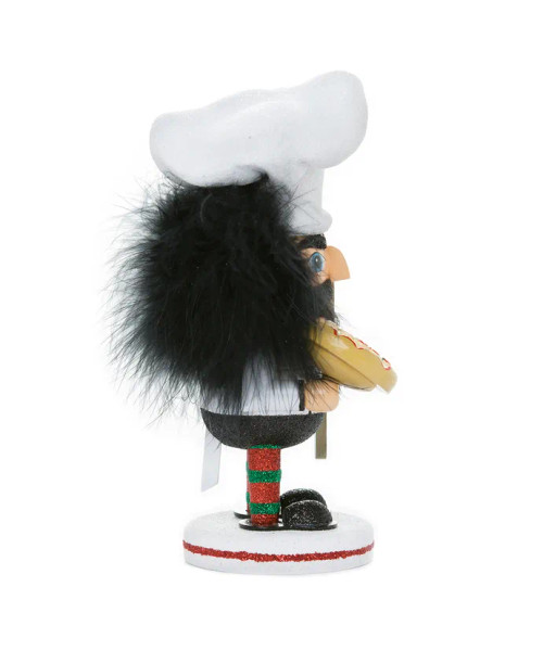 Side view features a pepperoni pizza, a wooden pizza peel, and is wearing a large white chef's hat. Side view features a pepperoni pizza, a wooden pizza peel, and is wearing a large white chef's hat.