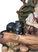 Bavarian boy, hand carved black cat perched on branch