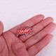 Daft Punk pin lying flat in palm of hand.