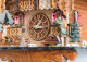 Partial side view of wooden dials and red carved shutters on the Rheinberg Musical Chalet German Quartz Cuckoo Clock