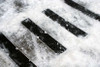 Heskins Bolt Down Anti-Slip Plates providing traction on outdoor steps in snowy winter conditions — heavy-duty pre-drilled plates rated for freeze-thaw exposure (shown with standard grit; photoluminescent glow version available for low-light egress)