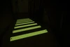 SafetyMark Glow Bolt Down plates in a stairwell during a power outage — photoluminescent afterglow provides emergency egress marking