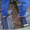 Person walking on Heskins Bolt Down Anti-Slip Plate on outdoor garden steps — Safety-Grip surface delivers 0.98 wet coefficient of friction for pedestrian traction in wet conditions