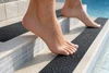 SafetyMark Coarse Resilient anti-slip tape applied to a pool step edge, safe for barefoot use