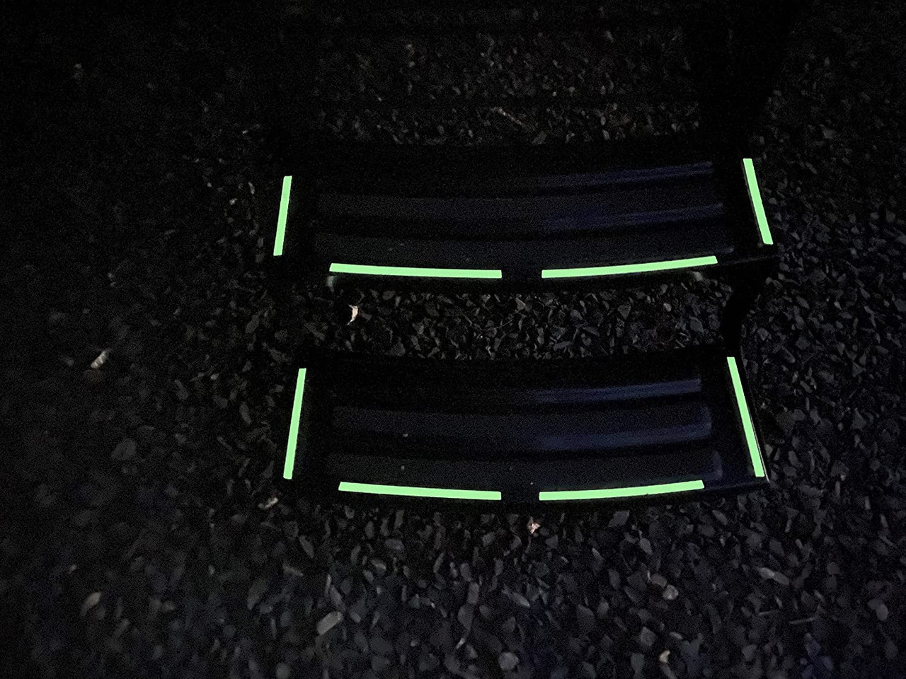 close-up of ifloortape Glow in The Dark Vinyl Decal Sticker Kit. Being demonstrated at night on trailer stairs.