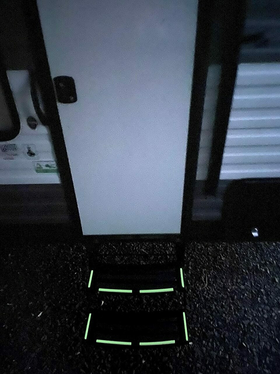 Glow in The Dark Vinyl Decal Sticker Kit. Being demonstrated at night  on metal stairs. (Pack of 100 Decals)