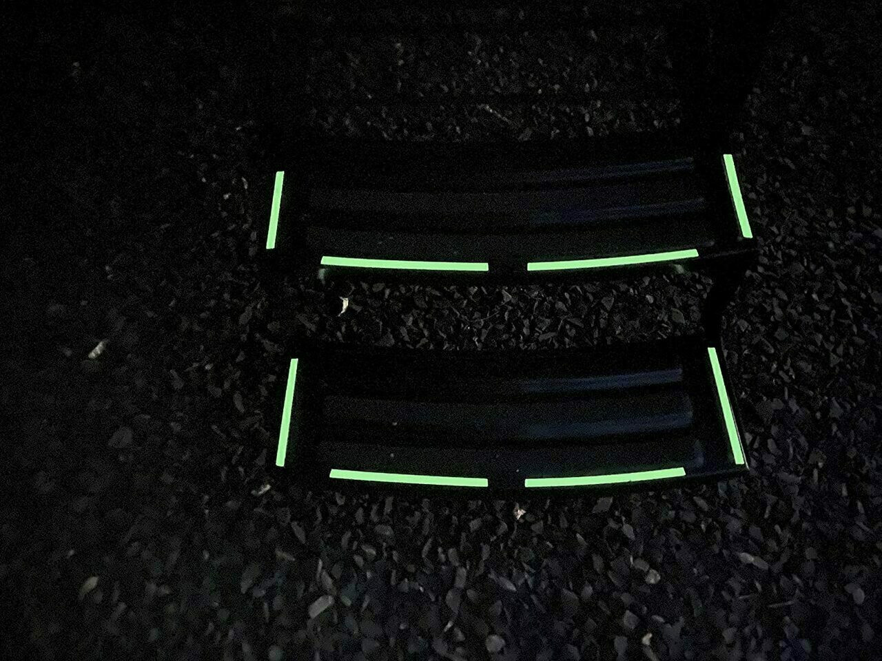 Close up of Glow in The Dark Vinyl Decal Sticker Kit. Being demonstrated at night  on metal stairs . (Pack of 34 Decals)