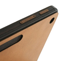 Detail of wood and leather cover for Microsoft Surface Pro 12 tablet.