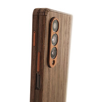 Detail of ebony and walnut cover for Samsung Fold4 folding smartphone.