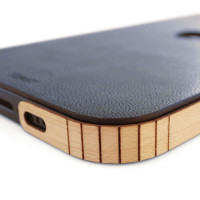 Corner detail of genuine leather wrap with Toast wood side covers, for iPhone 14, Plus, 14 Pro, and 14 Pro Max.  Pictured in Navy Grog blue leather with maple wraps.