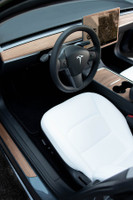 Tesla Model Y rosewood covering the dash, center console, steering wheel, screen surround and door step