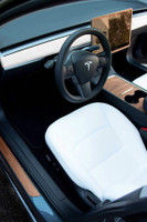Tesla Model Y rosewood covering the dash, center console, steering wheel, screen surround and door step