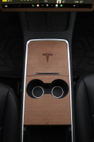 Tesla Model 3 Second Generation with walnut real wood covering center console with the Tesla custom logo laser etched into center console