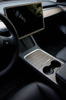 Tesla Model 3 Second Generation with ebony real wood covering center console, screen and dash. Tesla custom logo laser etched into center console