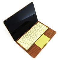 Detail of Toast cover from MacBook Neo, keyboard area in walnut wood.