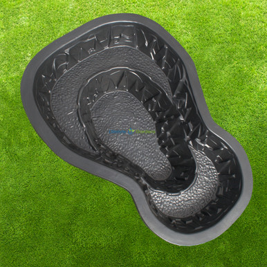 A preformed pond shell set into a planted garden bed