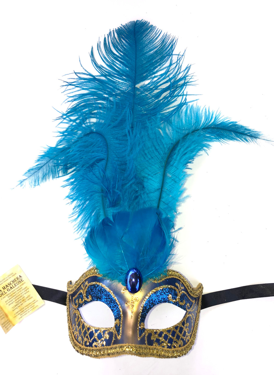 A woman in a feather Venetian mask poses during the Venice
