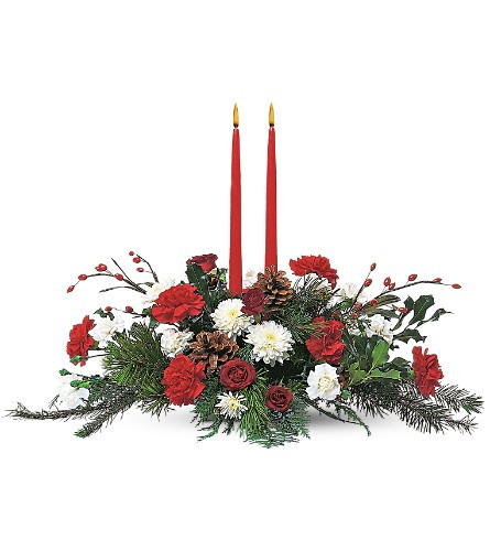 Long and Low centerpiece with two taper candles. Designed with Vermont winter greens, Red Carnations, White mums, Natural Pine Cones. Delivered locally by Chappell's Florist