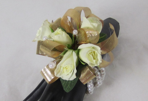 Graceful Gold Corsage. Designed on a white beaded bracelet. This Gold and white wrist corsage will dazzle her. An exclusive design by Chappell's Florist