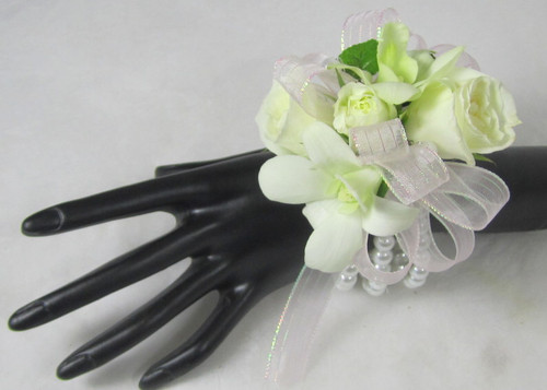 Beloved Blooms corsage for the wrist. Designed with orchids and roses. We can customize the ribbon to match your dress. A Chappell's exclusive