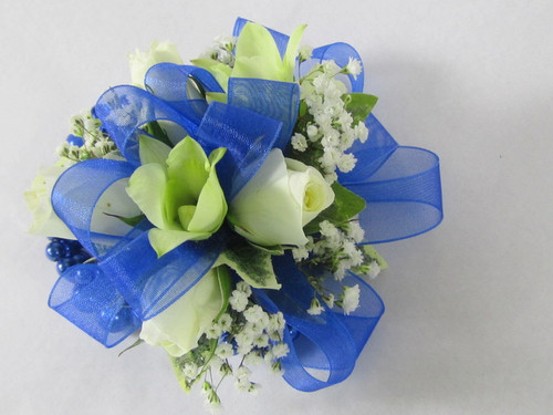 Beautiful Blue corsage designed with white orchids and white miniature spray roses with a touch of babies breath. Adorn her evening with this exclusive design by Chappells Florist.