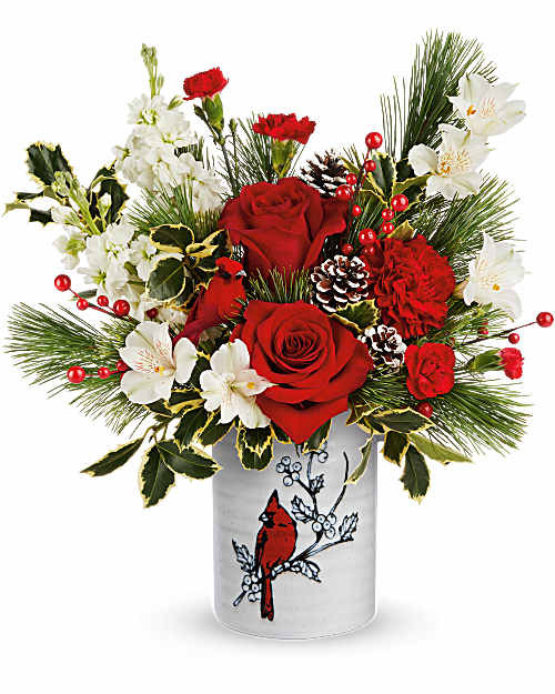 Teleflora's Woodland Cardinal Bouquet is a festive winter favorite! Red roses and carnations are hand-arranged with white blooms, pine, and holly in Teleflora's Woodland Cardinal Crock. A classic Christmas arrangement that brings seasonal color and charm to any space.