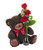 A cute Teddy Bear holding on to Three roses.