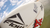 Zigfin stickers red and white on a surfboard.