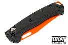 Benchmade Taggedout with carbon fiber handles and a orange coated blade.