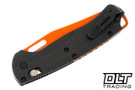Benchmade Taggedout with carbon fiber handles and a orange coated blade. 