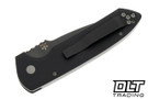 Pro-Tech Rockeye button lock knife with black handles and smoky grey blade