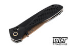 Benchmade Seven Ten folding knife with black handle and tan coated blade shown closed.