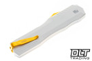 Kershaw Livewire "Pope" edition. It has a white aluminum handle and gold hardware, shown in the closed position. 