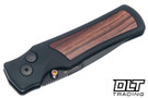 Hogue Saxum Manual - Matte Black Aluminum with Kingwood Inlay - Drop Point Black Cerakote MagnaCut Blade