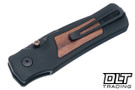 Hogue Saxum Manual - Matte Black Aluminum with Kingwood Inlay - Drop Point Black Cerakote MagnaCut Blade