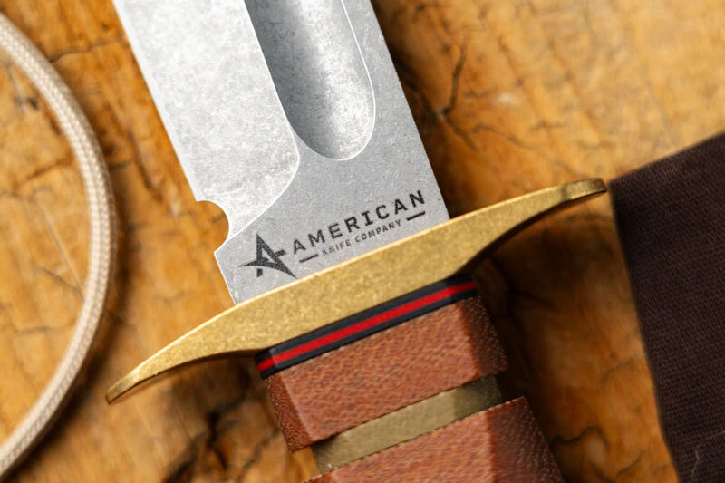 American Knife Company Mark 2 fixed blade with etched logo, brass guard, and stacked Micarta handle