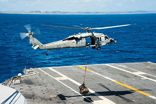 An MH-60S Sea Hawk delivers supplies onto the flight deck of USS George Washington Poster Print by Stocktrek Images (17 x 11)