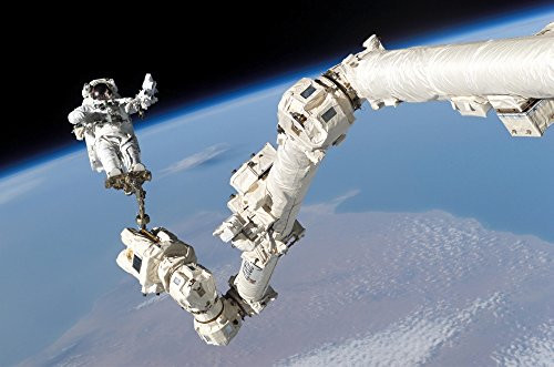 Astronaut anchored to a foot restraint on the International Space Stations Canadarm2 Poster Print 16 x 11