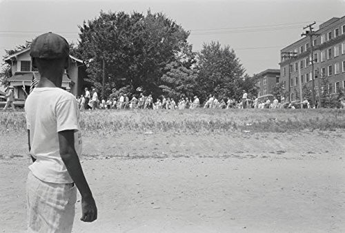 A young African American boy watches a mob marching from to Little Rock Central High 1959 Poster Print by Stocktrek Images  17 x 11