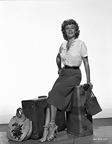 Rita Hayworth sitting on the Luggage with a Hand on Waist Pose Photo Print 8 x 10