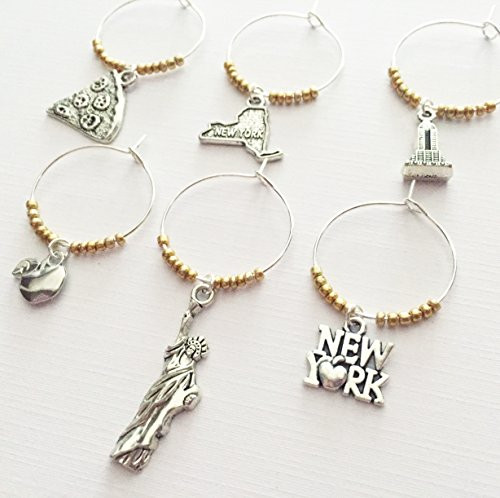 New York Wine Charms New York City themed wine charm gift. Charms include New York State New York signage Apple Statue of Liberty and Empire State Building New York Wine Charms New York City themed wine charm gift. Charms include New York State New York signage Apple Statue of Liberty and Empire State Building