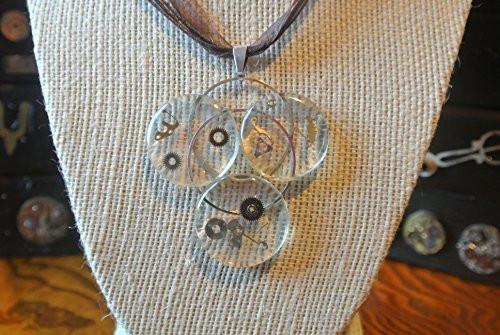 Time is Real Three round crystals with watch parts on brown ribbon chain.