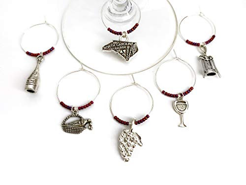 North Carolina Wine Charms, Gift for North Carolinian Wine lover. Includes North Carolina State, Grapes, Wine Bottle, Cheers glasses, picnic basket, and corkscrew charms. Set of 6. BURGUNDY BEADS.