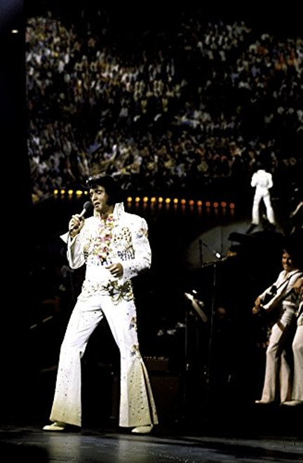 Elvis Presley performing in a white jumpsuit Photo Print -8 x 10-