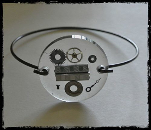 A Link to Time-Round watch crystal with Silver watch link and watch parts on antique bangle bracelet
