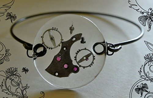 Lost in Time-Round watch crystal with watch parts on a antique bangle bracelet