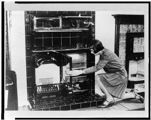 HistoricalFindings Photo: Woman Examining,British Combination Cook-Stove,Fireplace,London,England,1920