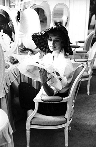 Sophia Loren looking at a hat Photo Print (8 x 10)