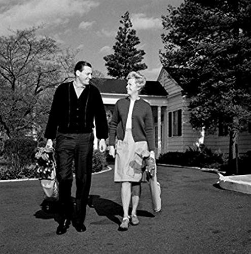 Posterazzi Mid Adult Couple Walking Poster Print by side carrying golf clubs (18 x 24)